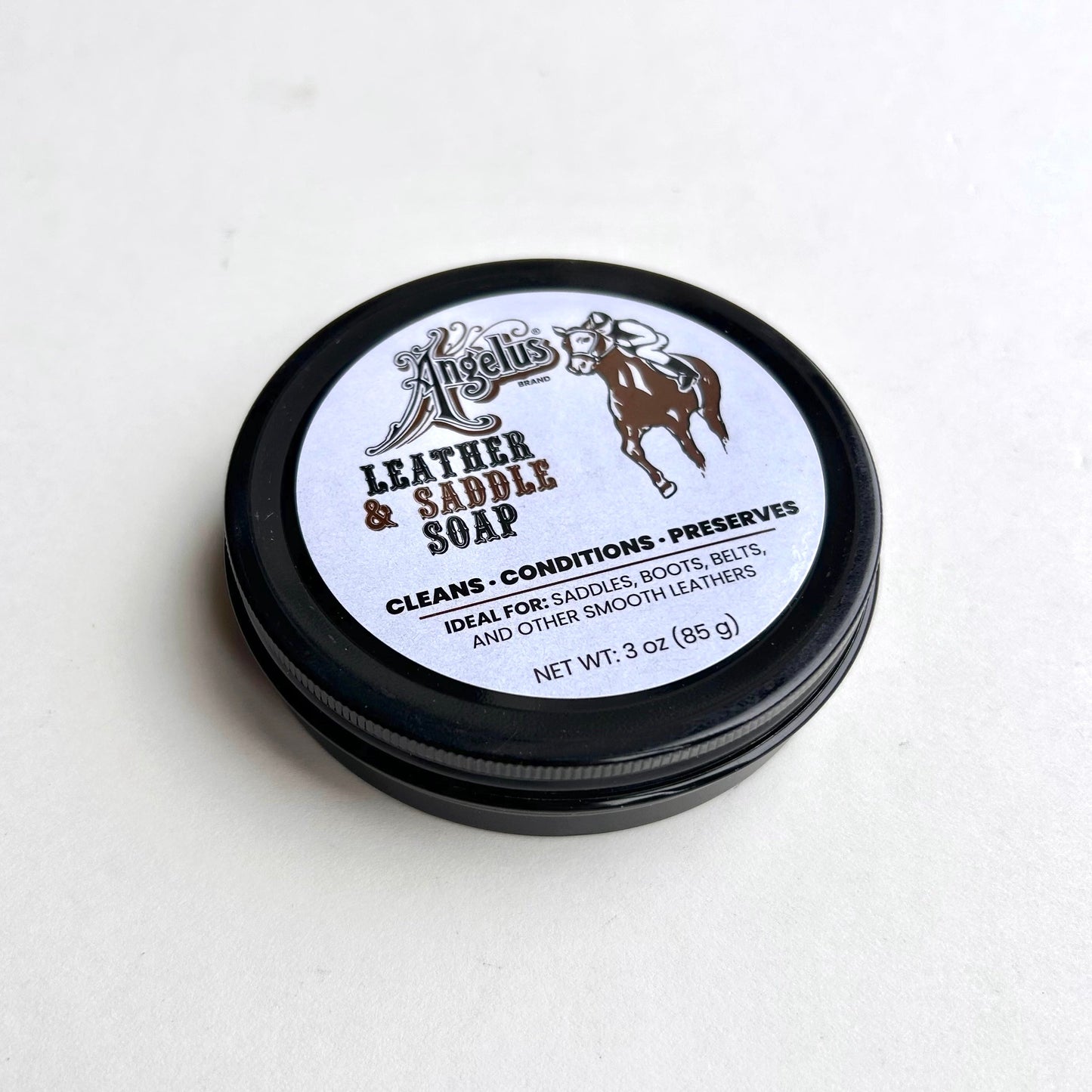 Jar of leather and saddle soap with a white label on a light gray background