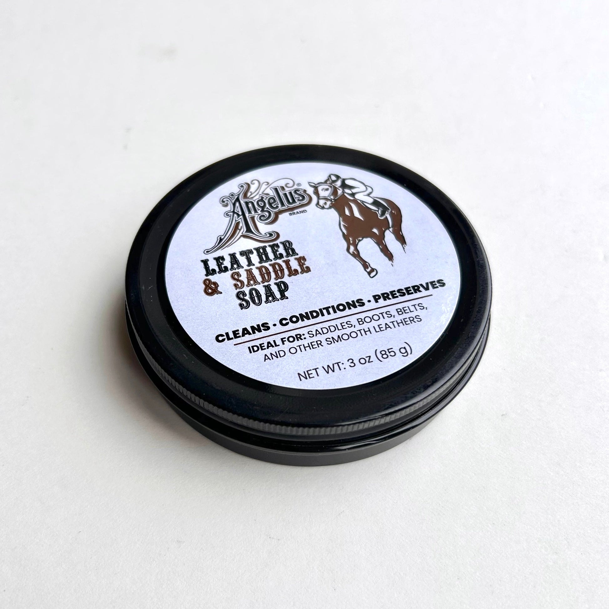 Jar of leather and saddle soap with a white label on a light gray background