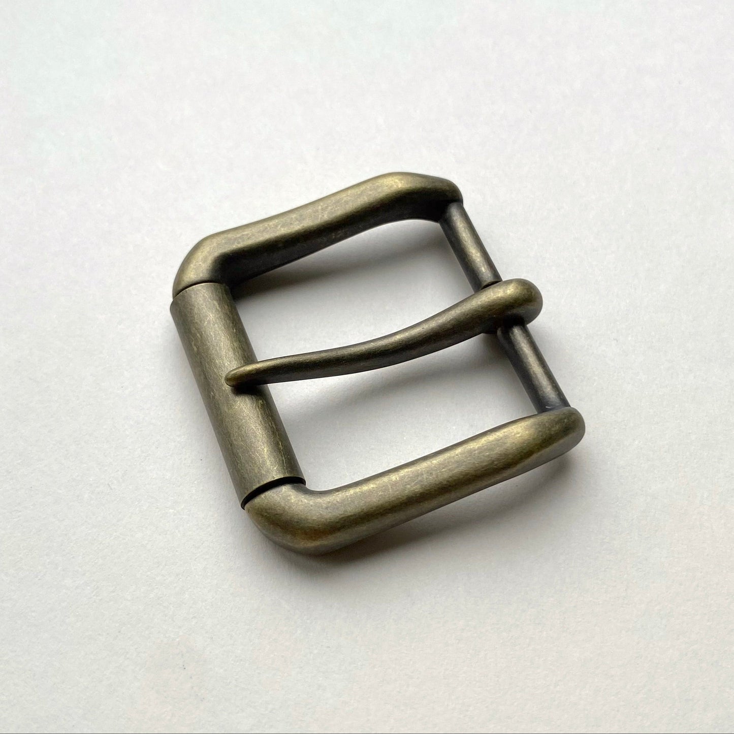 Metallic belt buckle on a white background