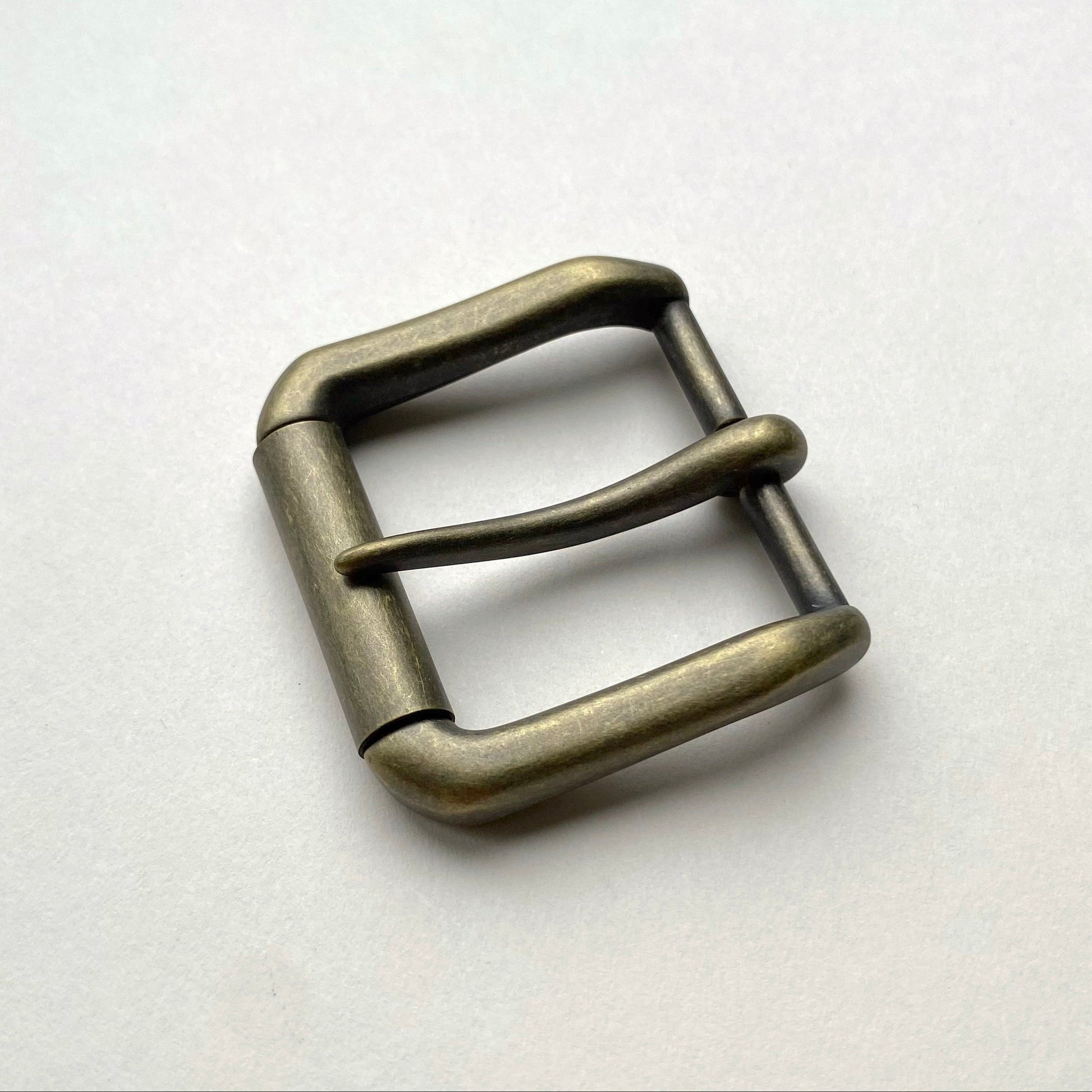 Metallic belt buckle on a white background
