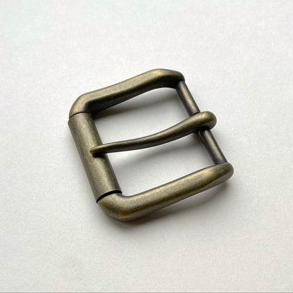 Metallic belt buckle on a white background