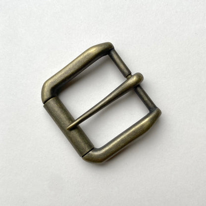 Bronze metal buckle on a white background