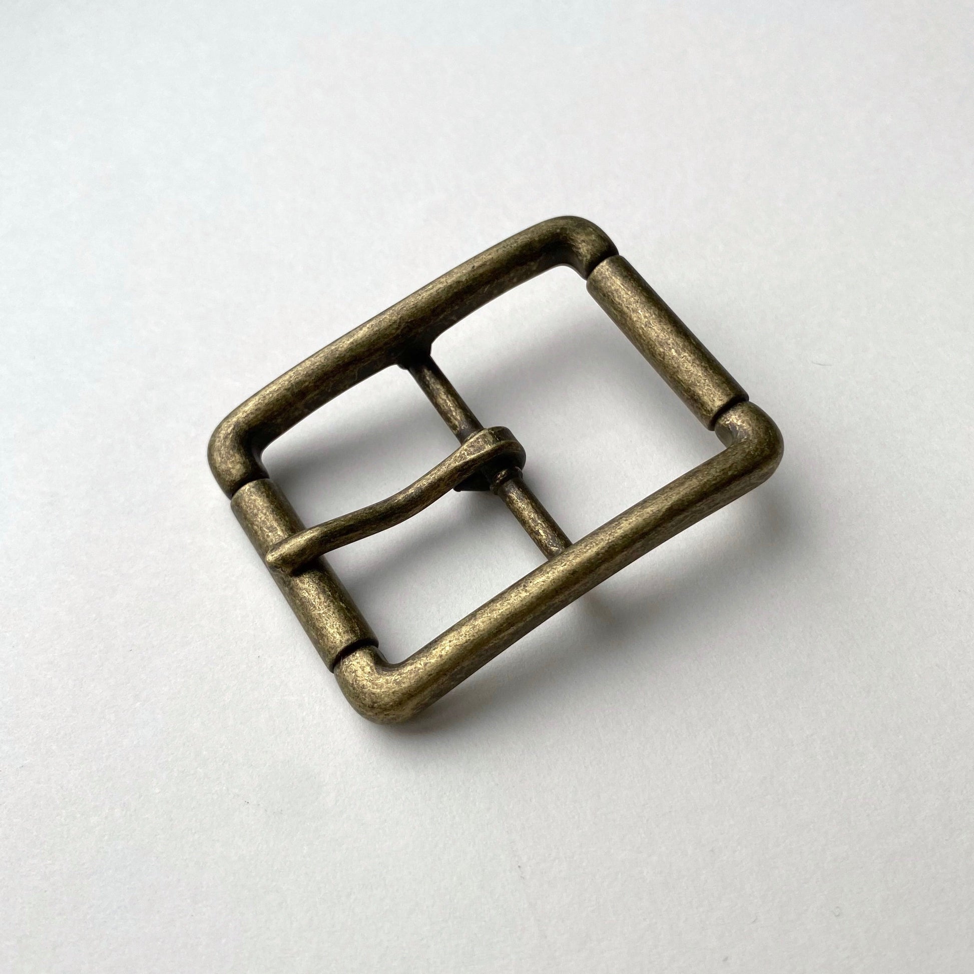 Bronze belt buckle on a white background