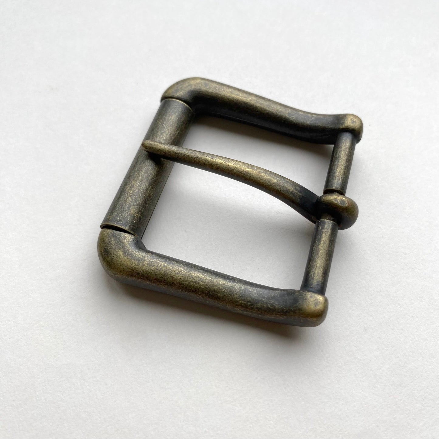 Bronze metal buckle on a white background