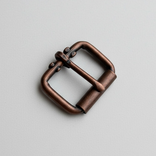 Antique copper roller buckle on a white background
