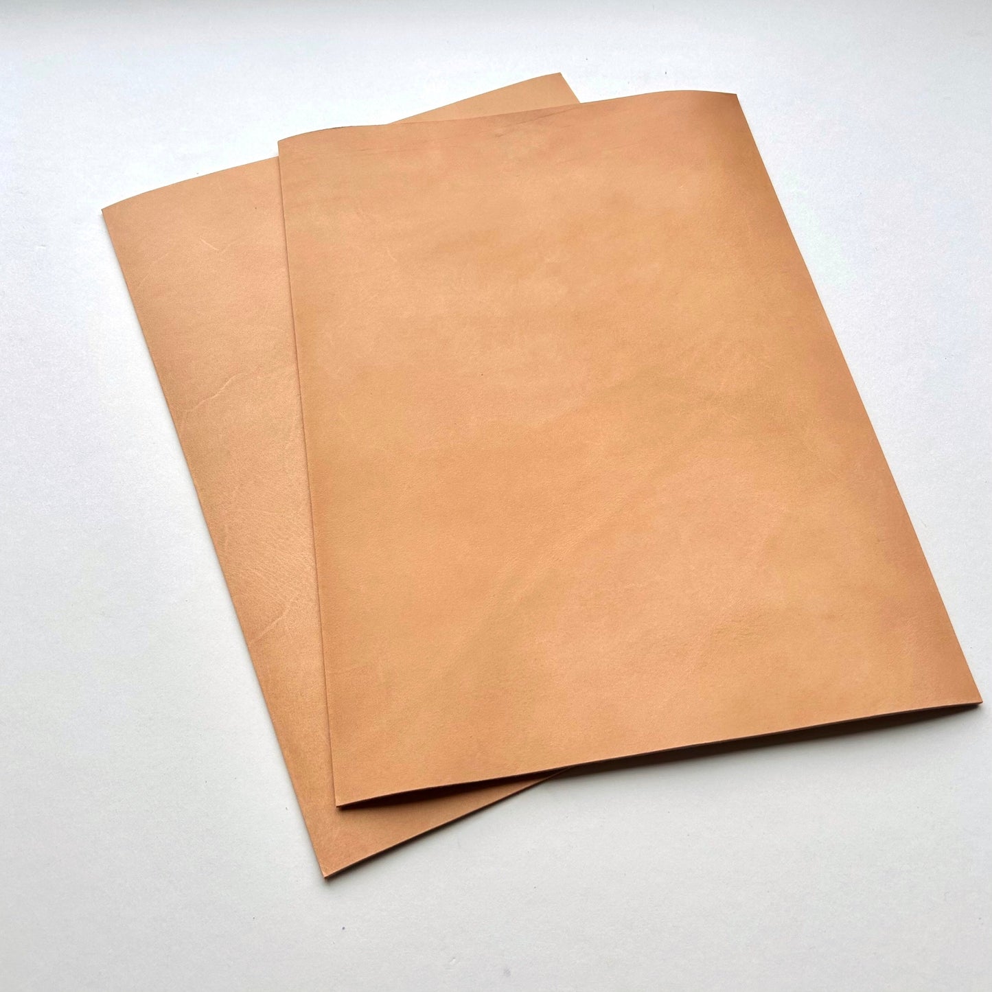 Three pieces of natural leather on a white background
