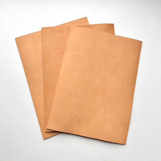 Three pieces of natural leather on a white background