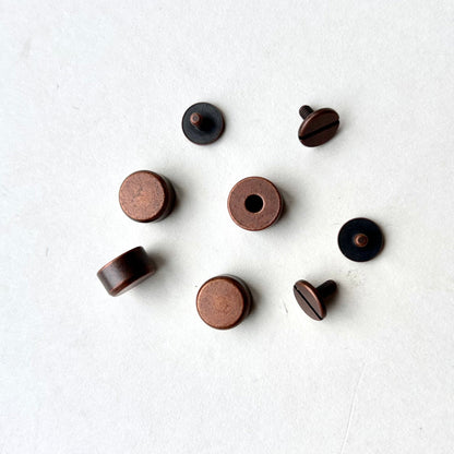 Set of copper screw feet on a white background