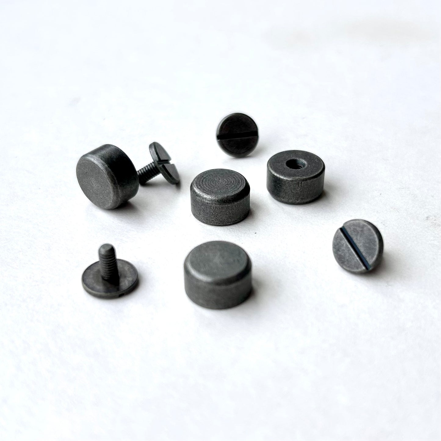 Set of black metal bag feet on a white background