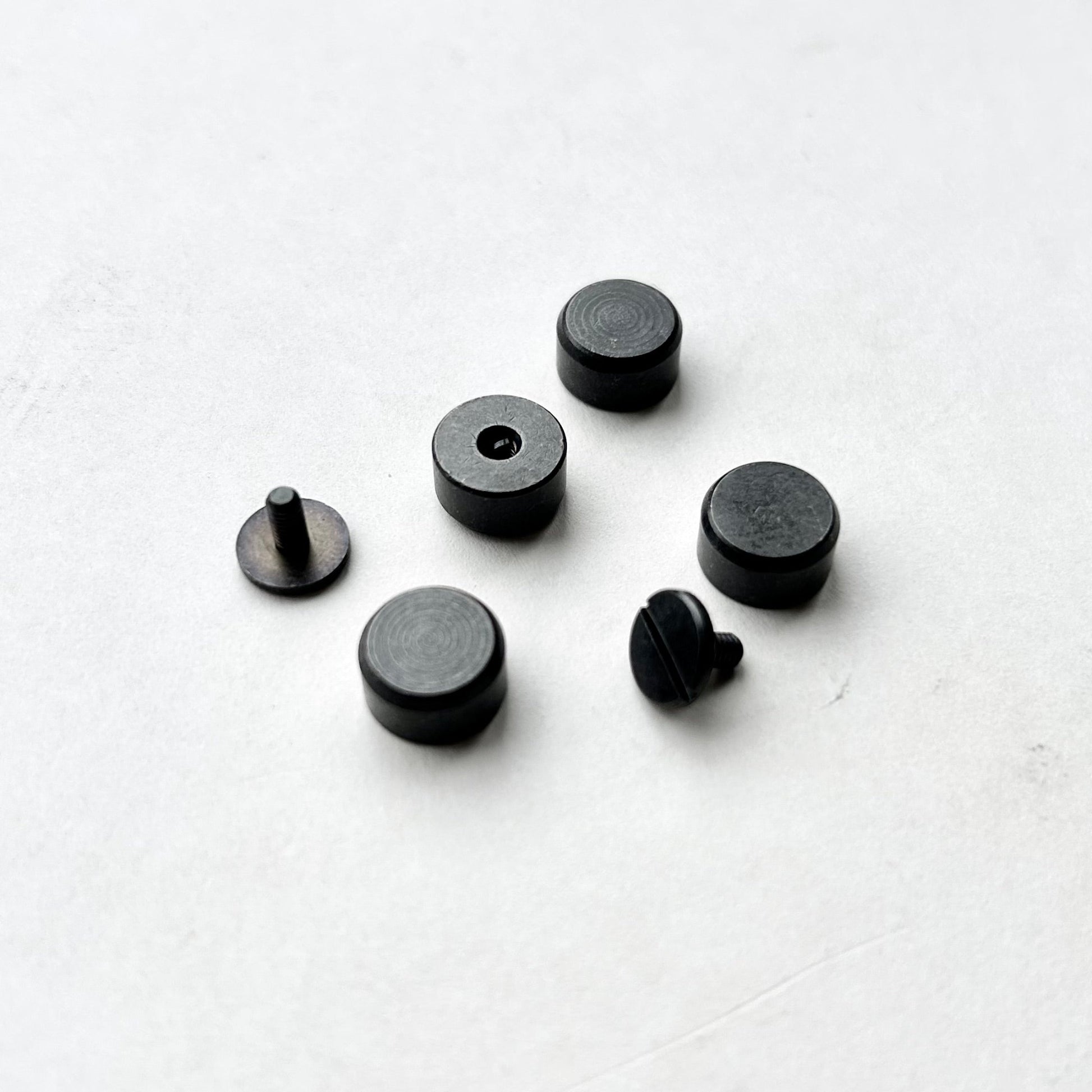 Set of Gun Metal bag feet studs on a white background