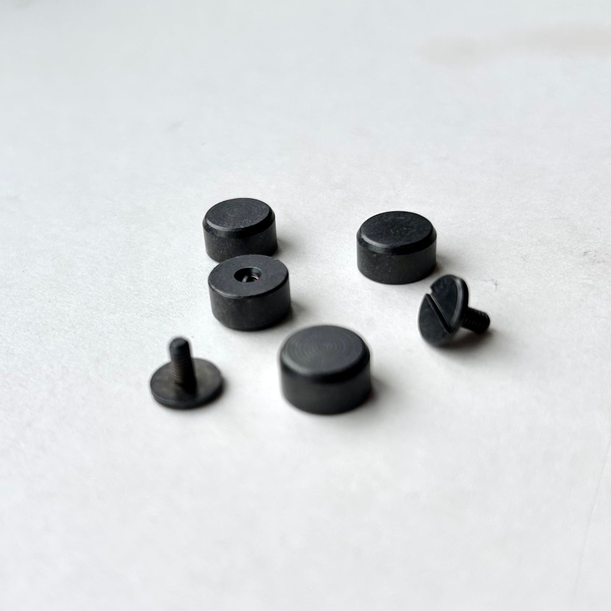 Set of Gun Metal bag feet studs on a white background