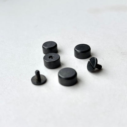 Set of Gun Metal bag feet studs on a white background