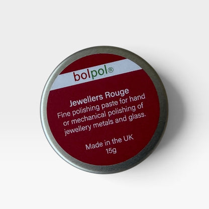 A round metal tin of bolpol Jewellers Rouge polishing paste on a light gray background. The lid features a deep red label with white text detailing the product's use for jewelry metals and glass.