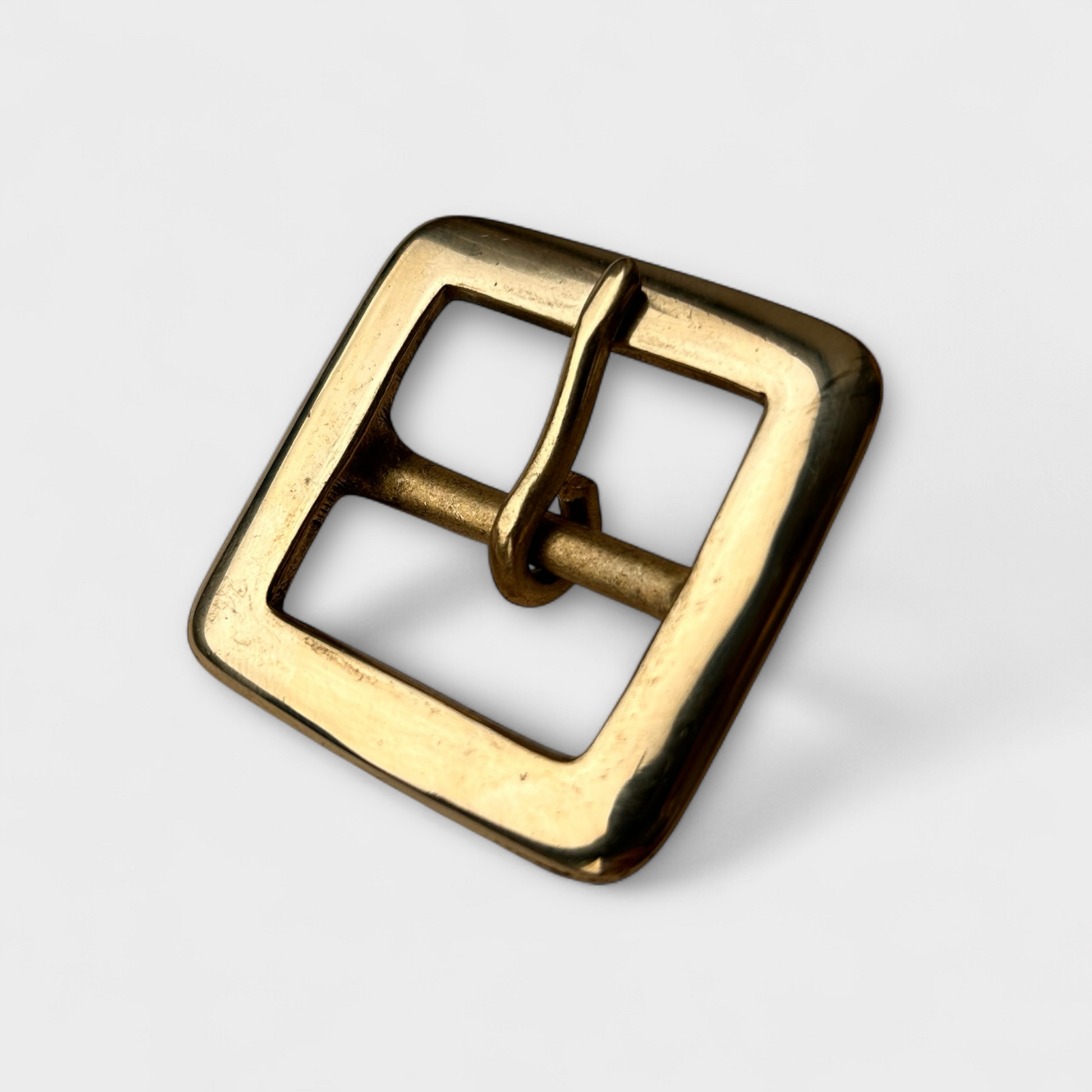 Solid Brass centre bar style buckle with a rounded end in frame and pin style. 