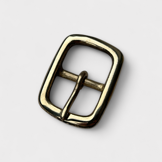 Brass belt buckle on a white background