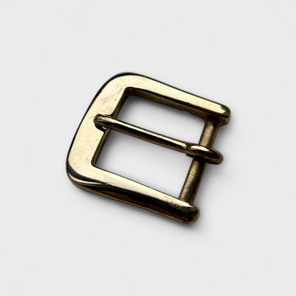 Gold metal buckle on a white background