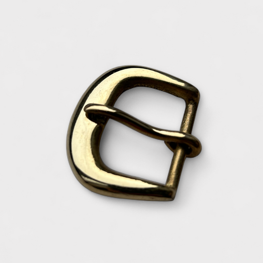 Gold metal buckle on a light gray background