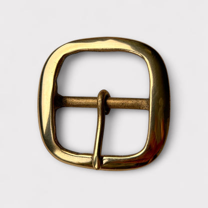 Large gold coloured brass metal buckle with a centre bar on a white background.