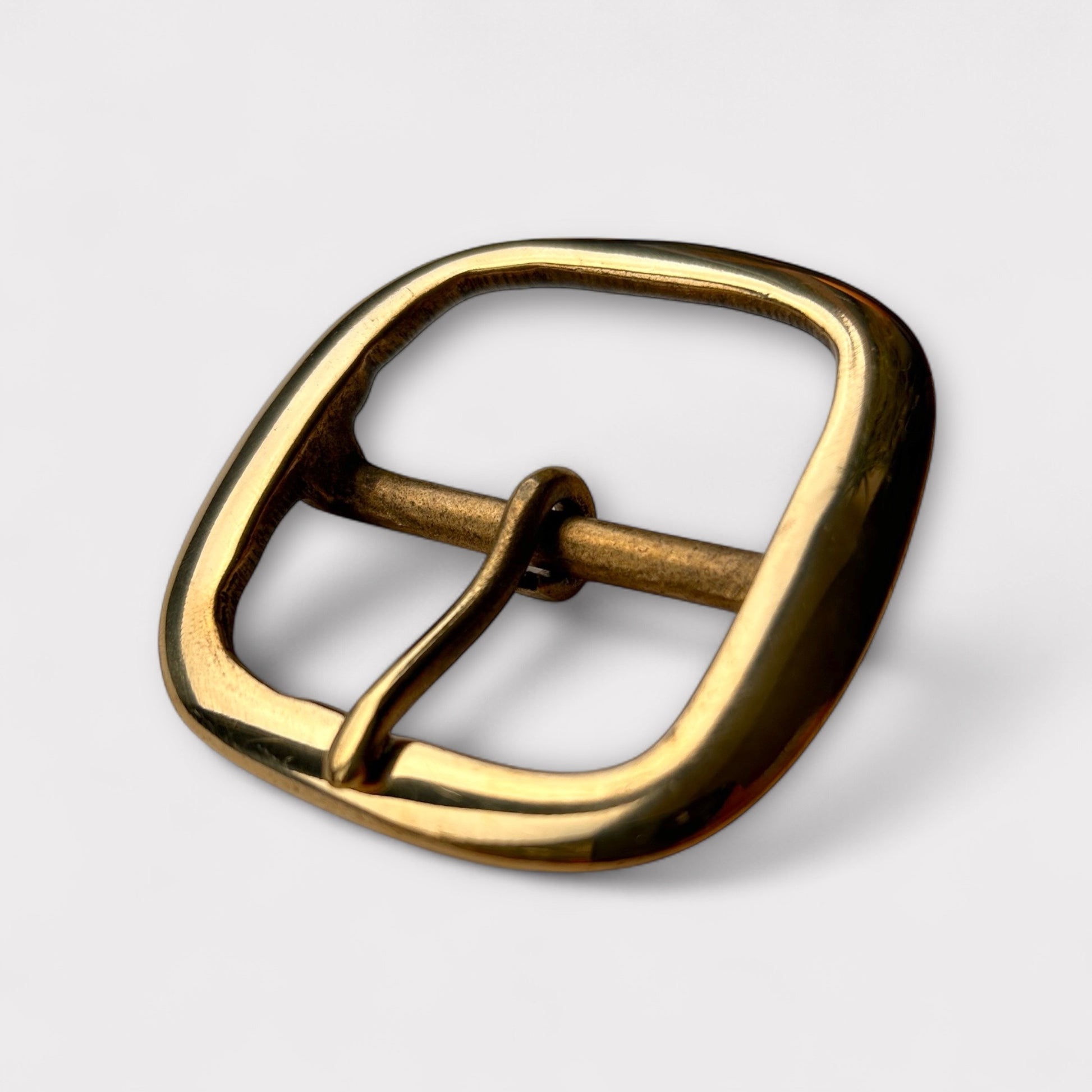 Large gold coloured brass metal buckle with a centre bar on a white background.