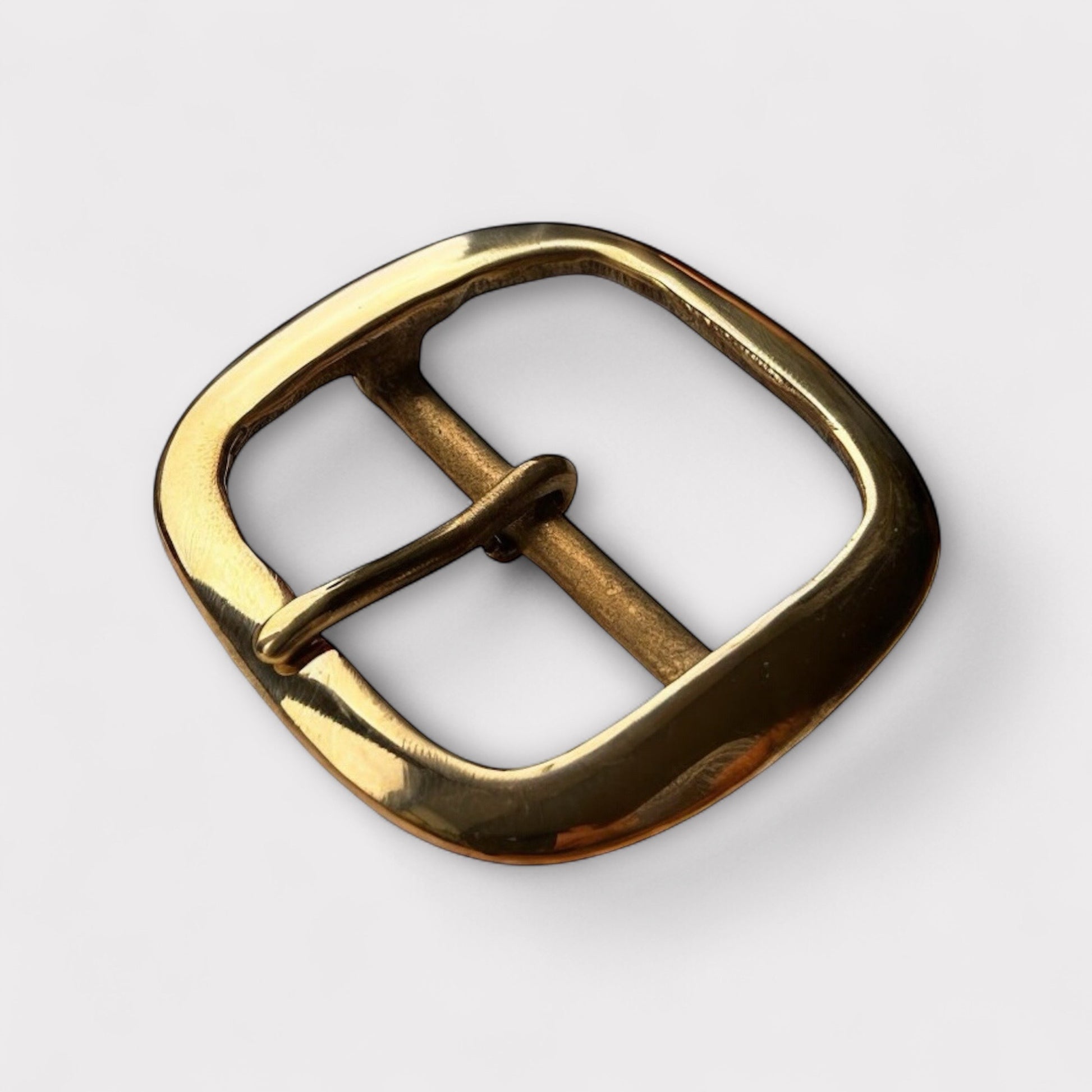 Large gold coloured brass metal buckle with a centre bar on a white background.