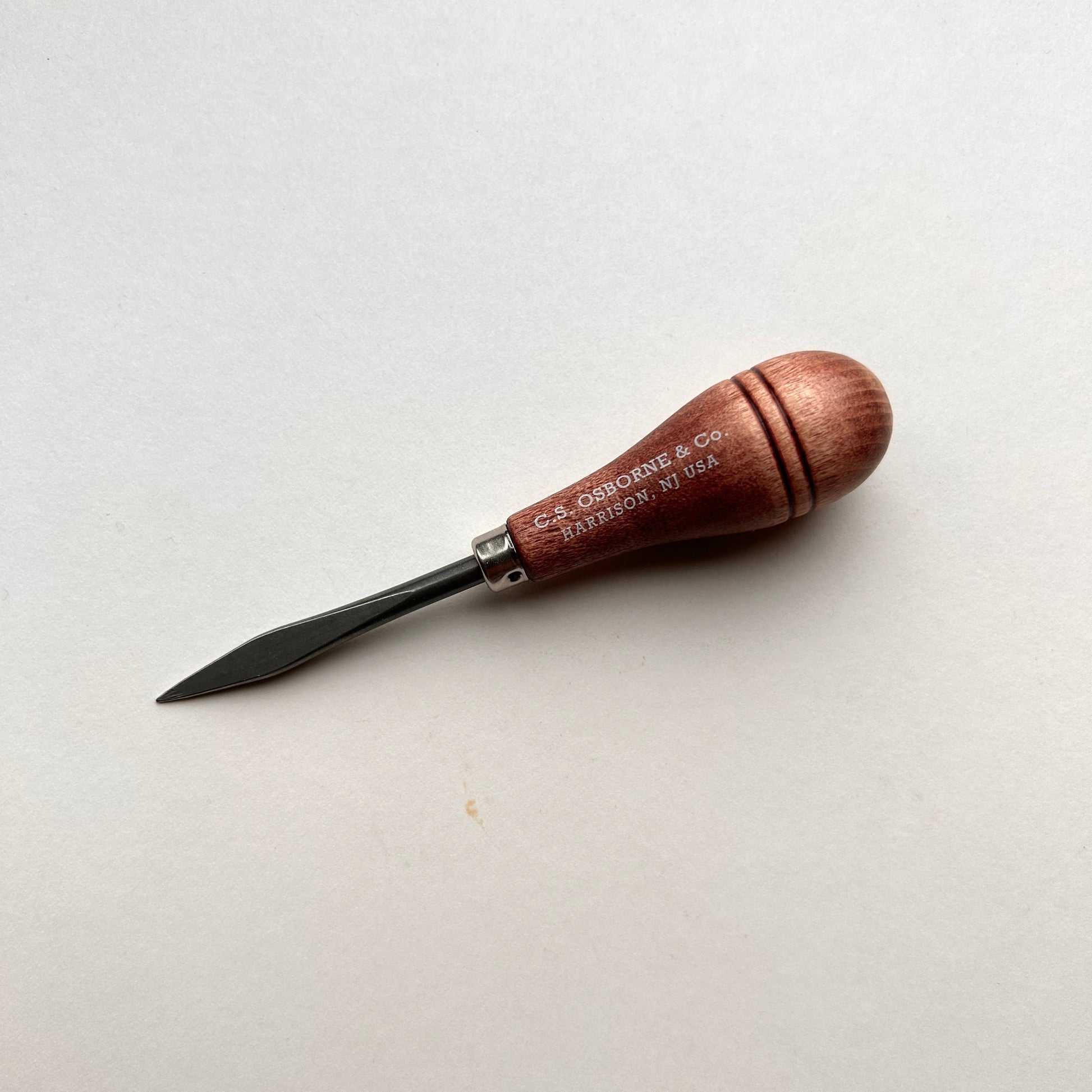 CS Osborne wooden-handled belt awl on a white background