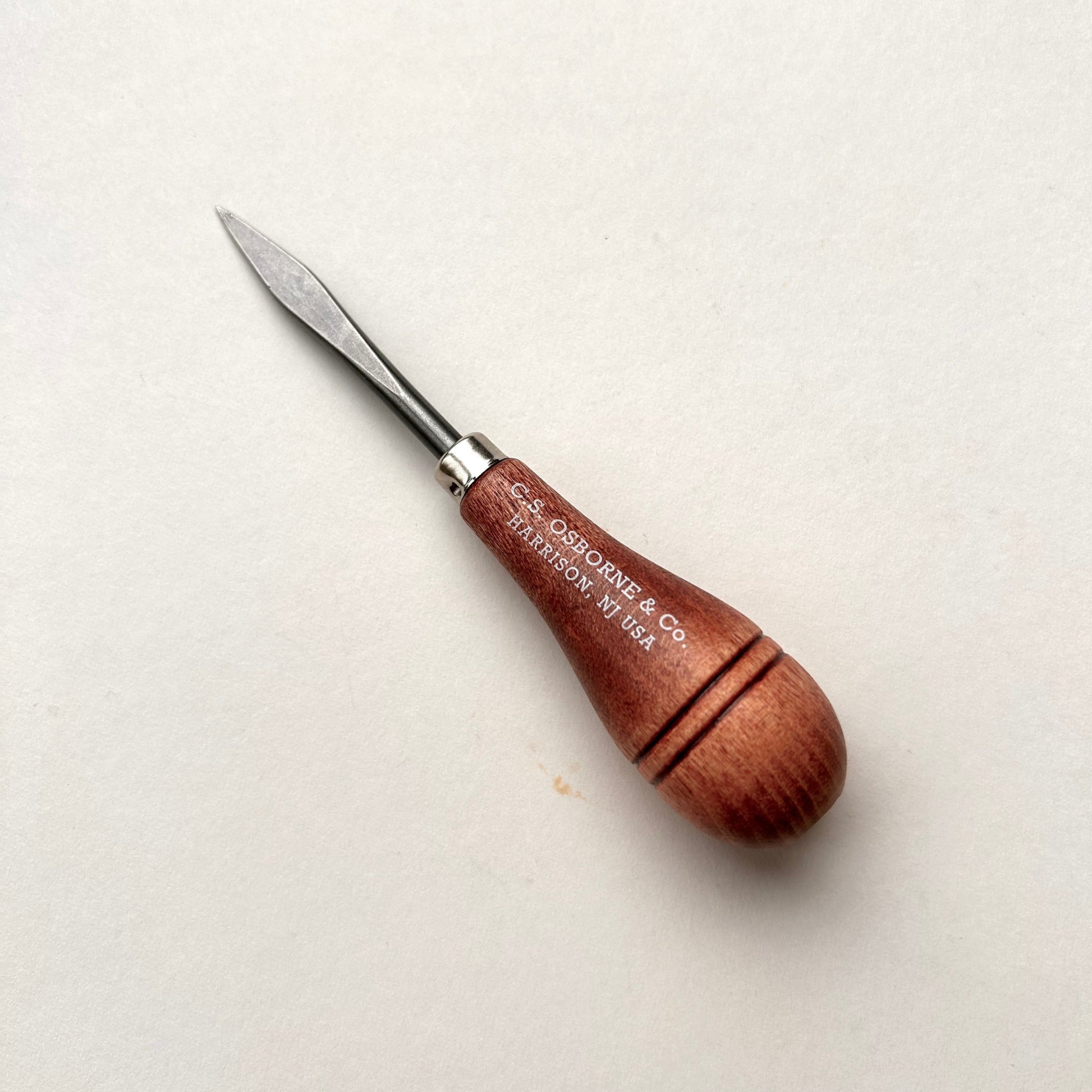CS Osborne wooden-handled belt awl on a white background