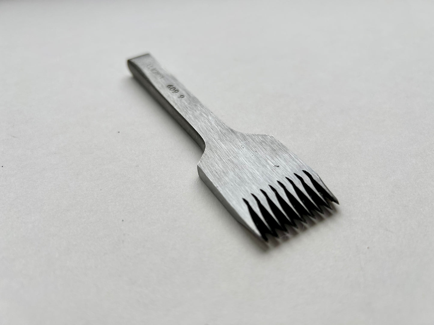 CS Osborne steel leather pricking irons metal tool with teeth on a white background