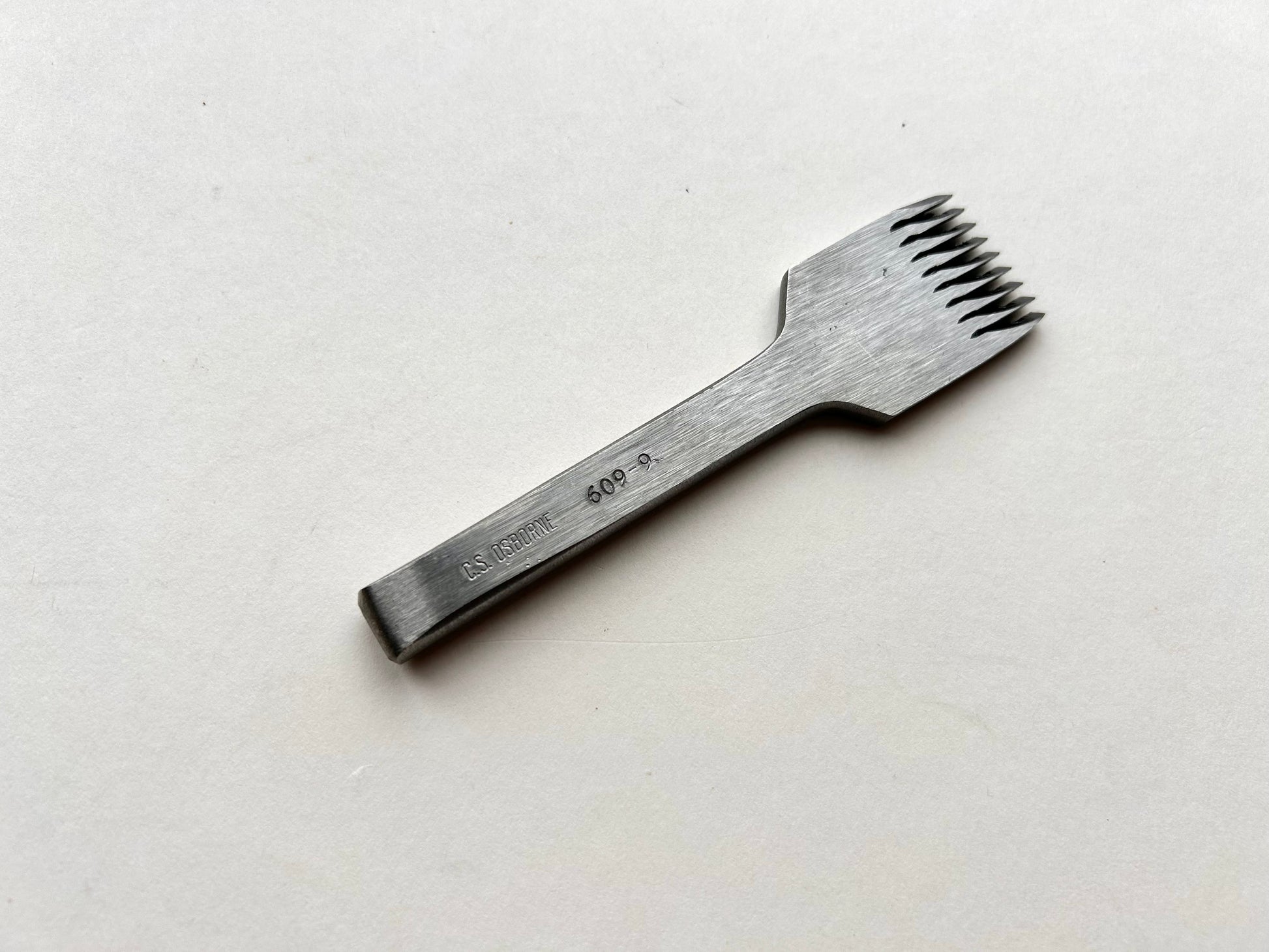 CS Osborne steel leather pricking irons metal tool with teeth on a white background