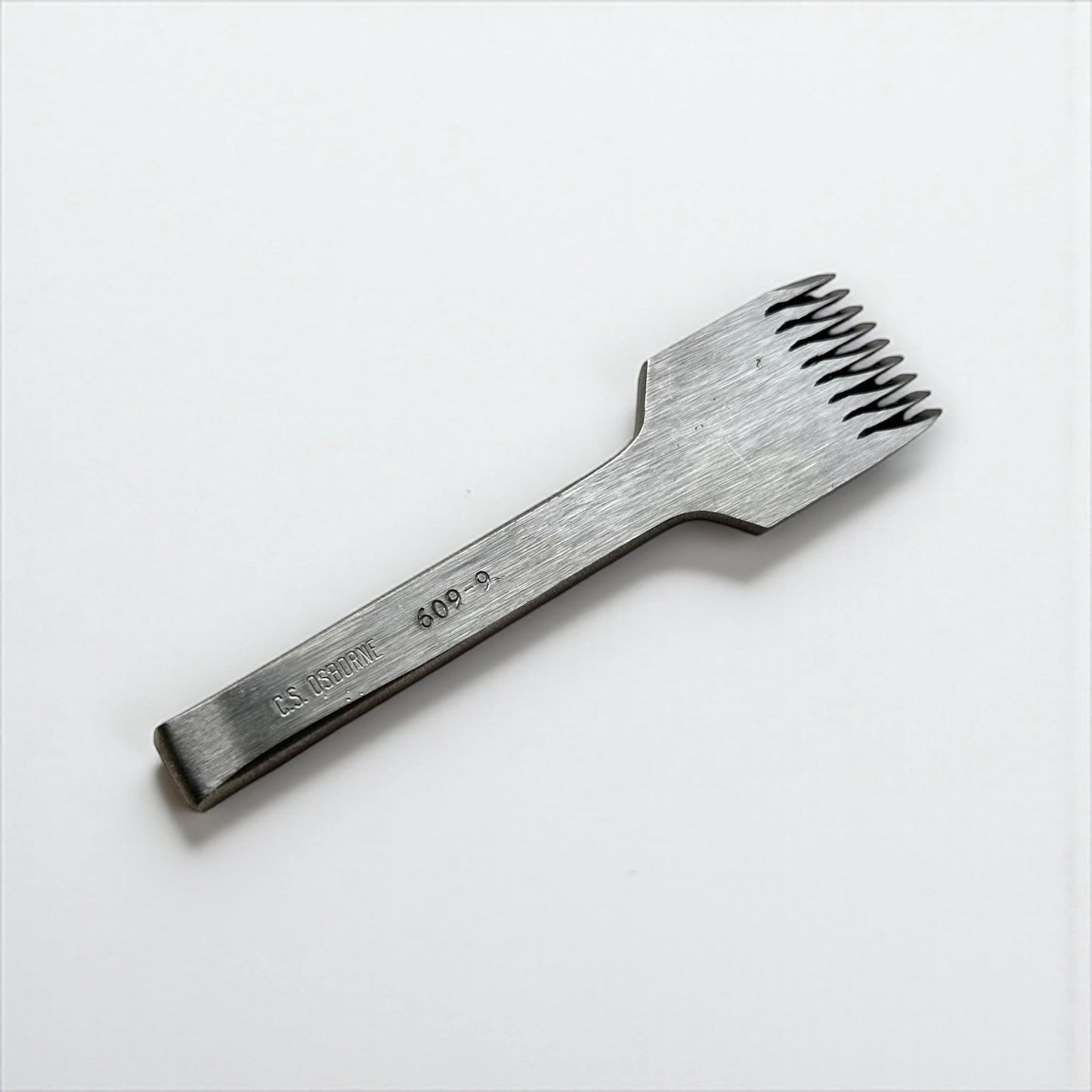 CS Osborne steel leather pricking irons metal tool with teeth on a white background