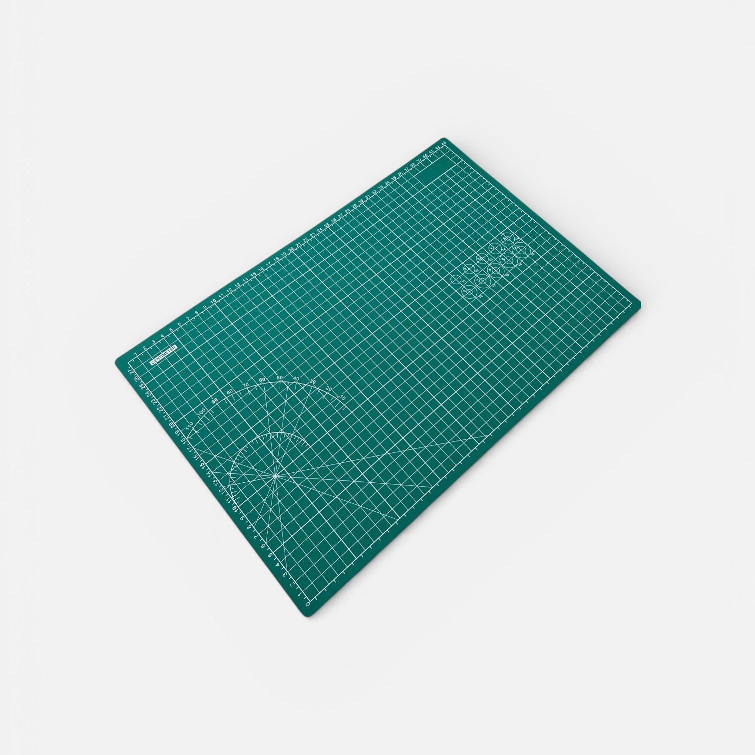 Green cutting mat with grid lines on a white background