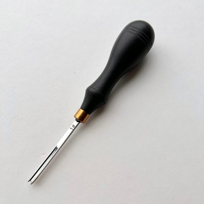 Ebony-handled leather edge beveller on a white background