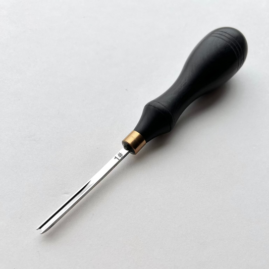 Ebony-handled leather edge beveller on a white background