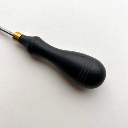 Ebony-handled leather edge beveller on a white background