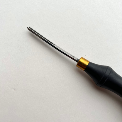 Ebony-handled leather edge beveller on a white background