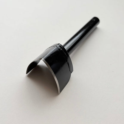 A black metal strap end punch with a long shank, photographed on a plain light grey background.
