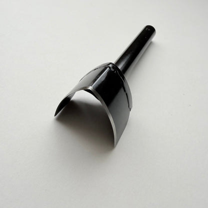 A black metal strap end punch with a long shank, photographed on a plain light grey background.