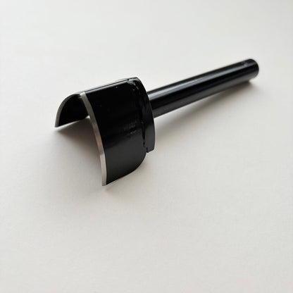 A black metal strap end punch with a long shank, photographed on a plain light grey background.