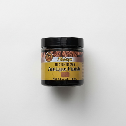 Jar of medium brown antique finish leather dye on a white background