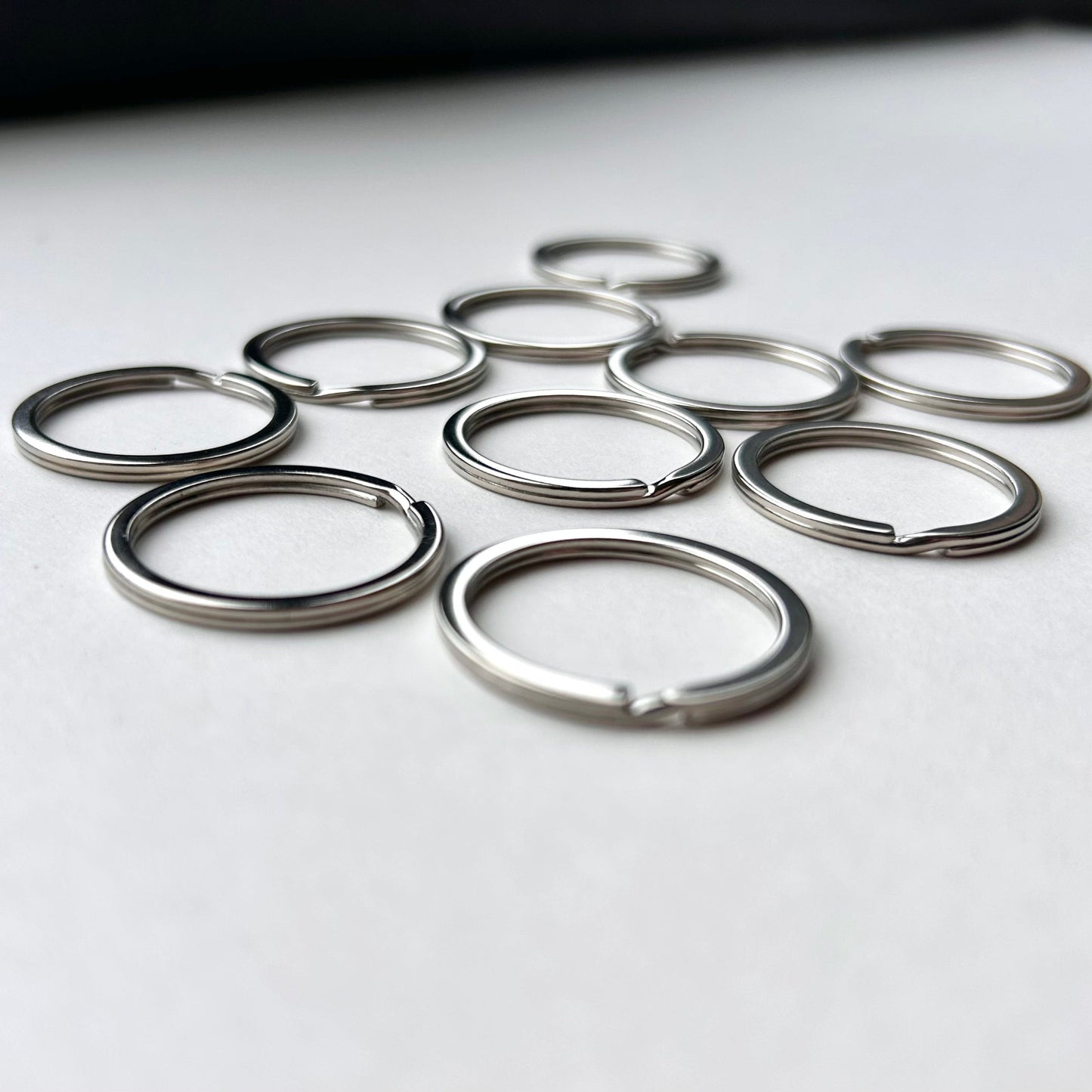 Set of metal keyrings on a white surface