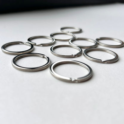 Set of metal keyrings on a white surface