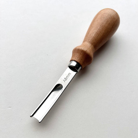 Wooden-handled french leather edge skiver tool on a white background