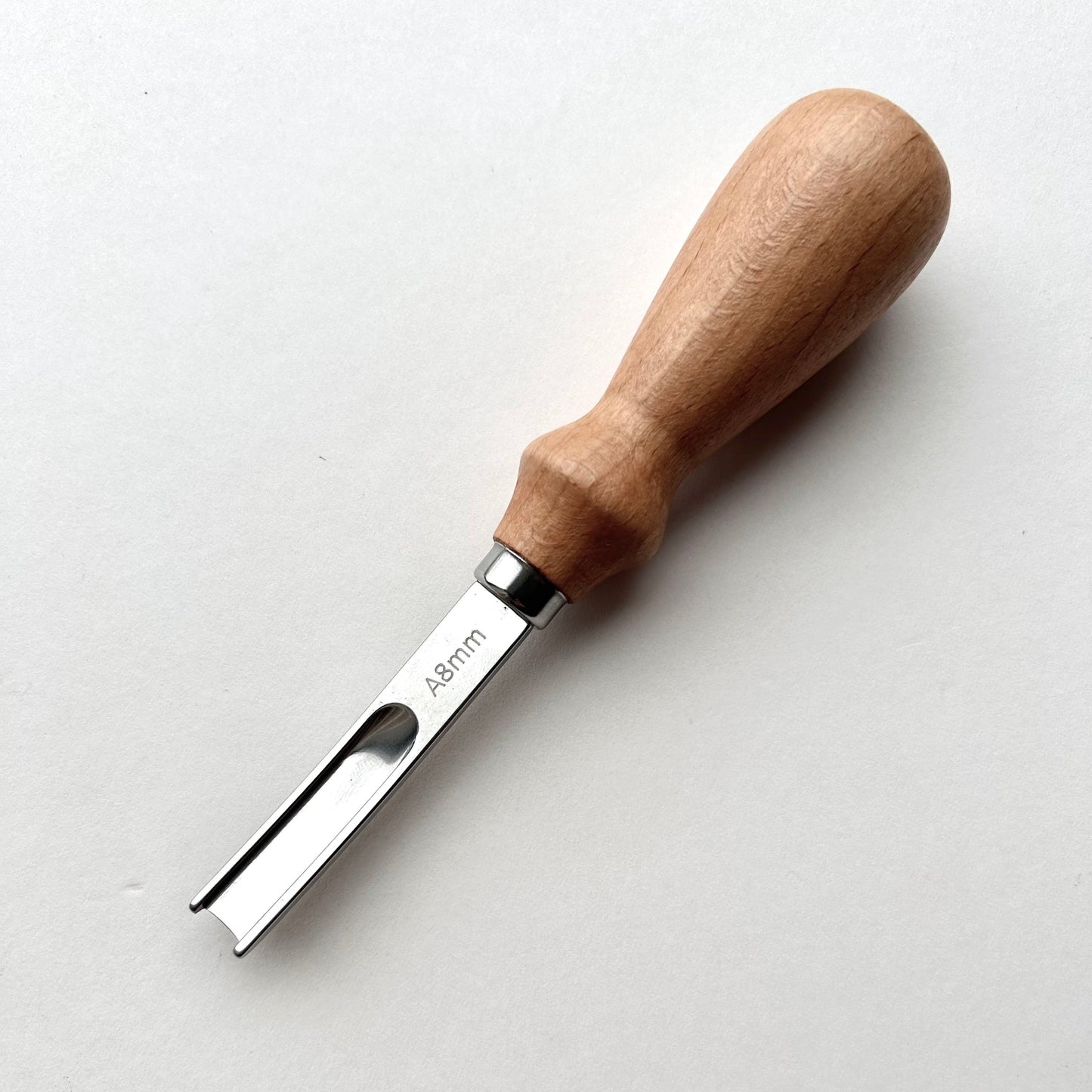 Wooden-handled french leather edge skiver tool on a white background