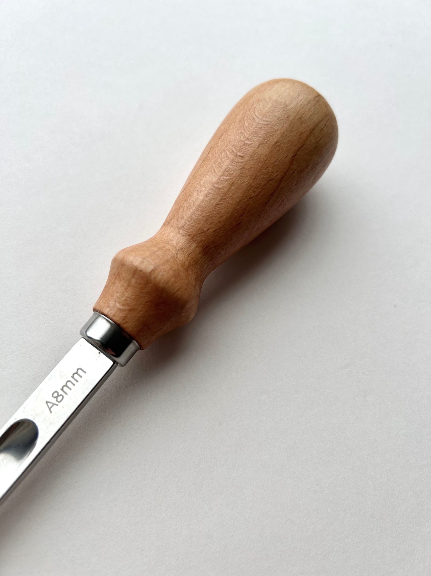 Wooden-handled french leather edge skiver tool on a white background