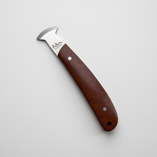 Leatherwork knife with a brown handle on a light grey background