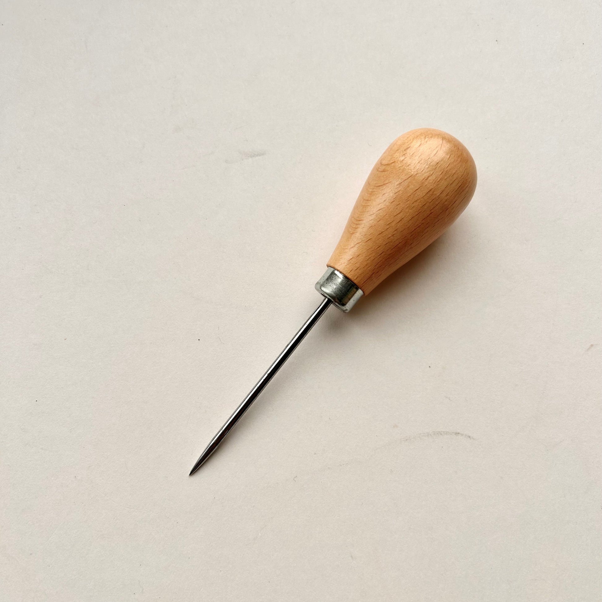 Wooden-handled awl on a white background