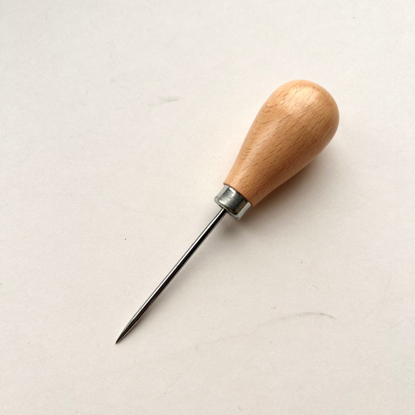Wooden-handled awl on a white background
