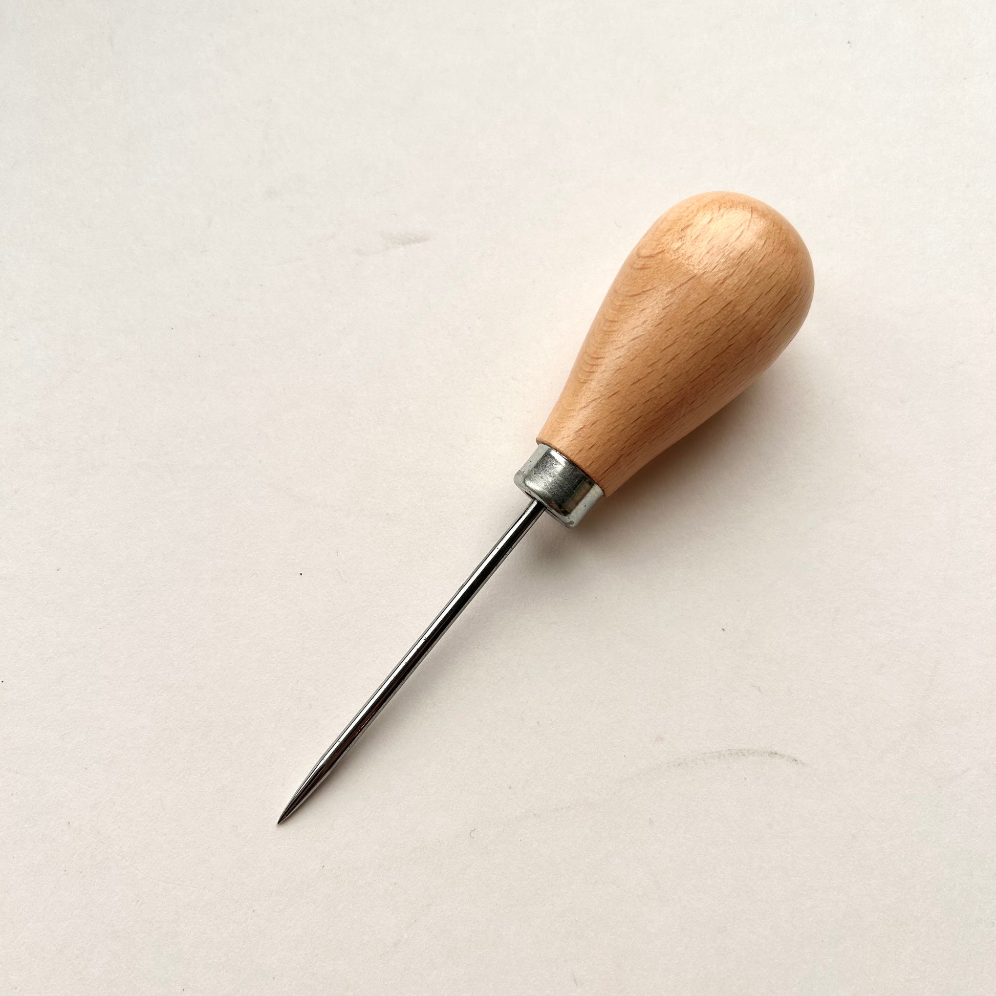 Wooden-handled awl on a white background