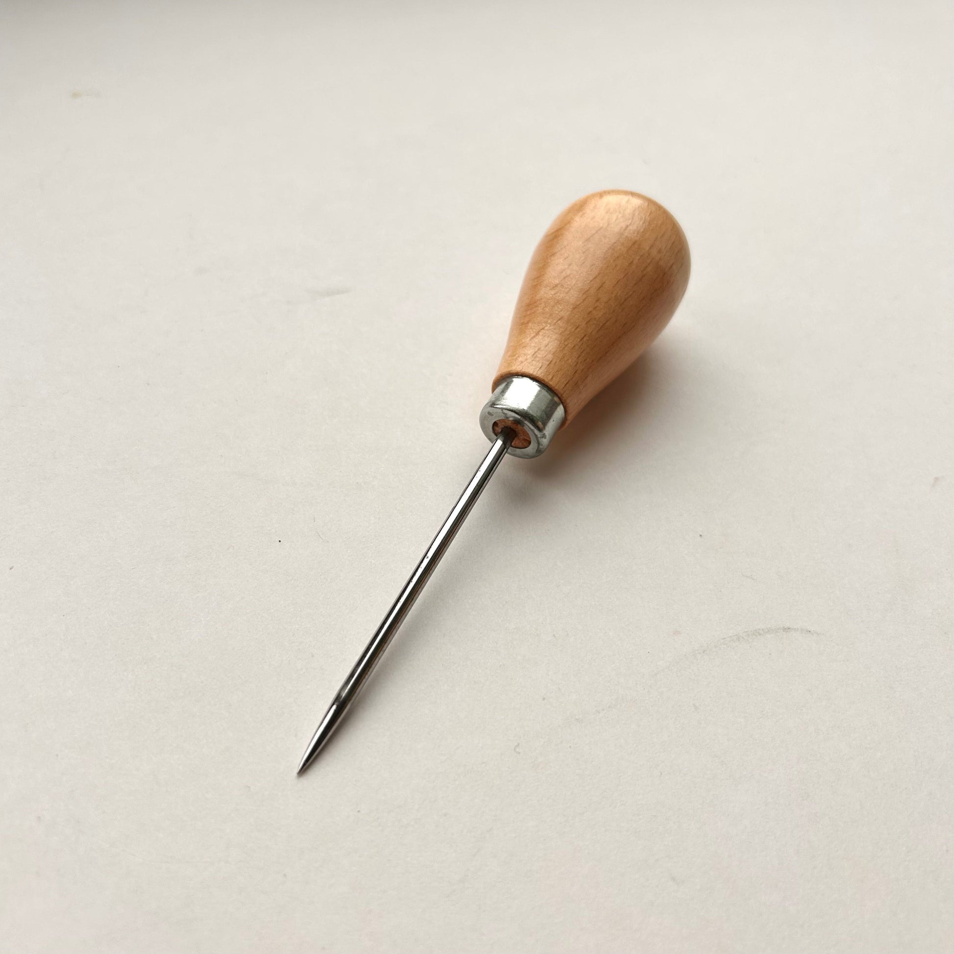 Wooden-handled awl on a white background