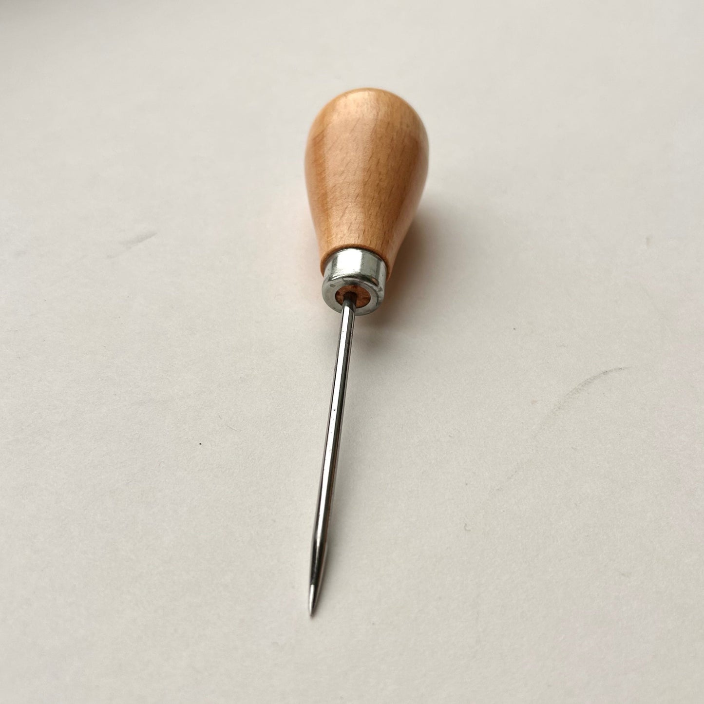 Wooden-handled awl on a white background