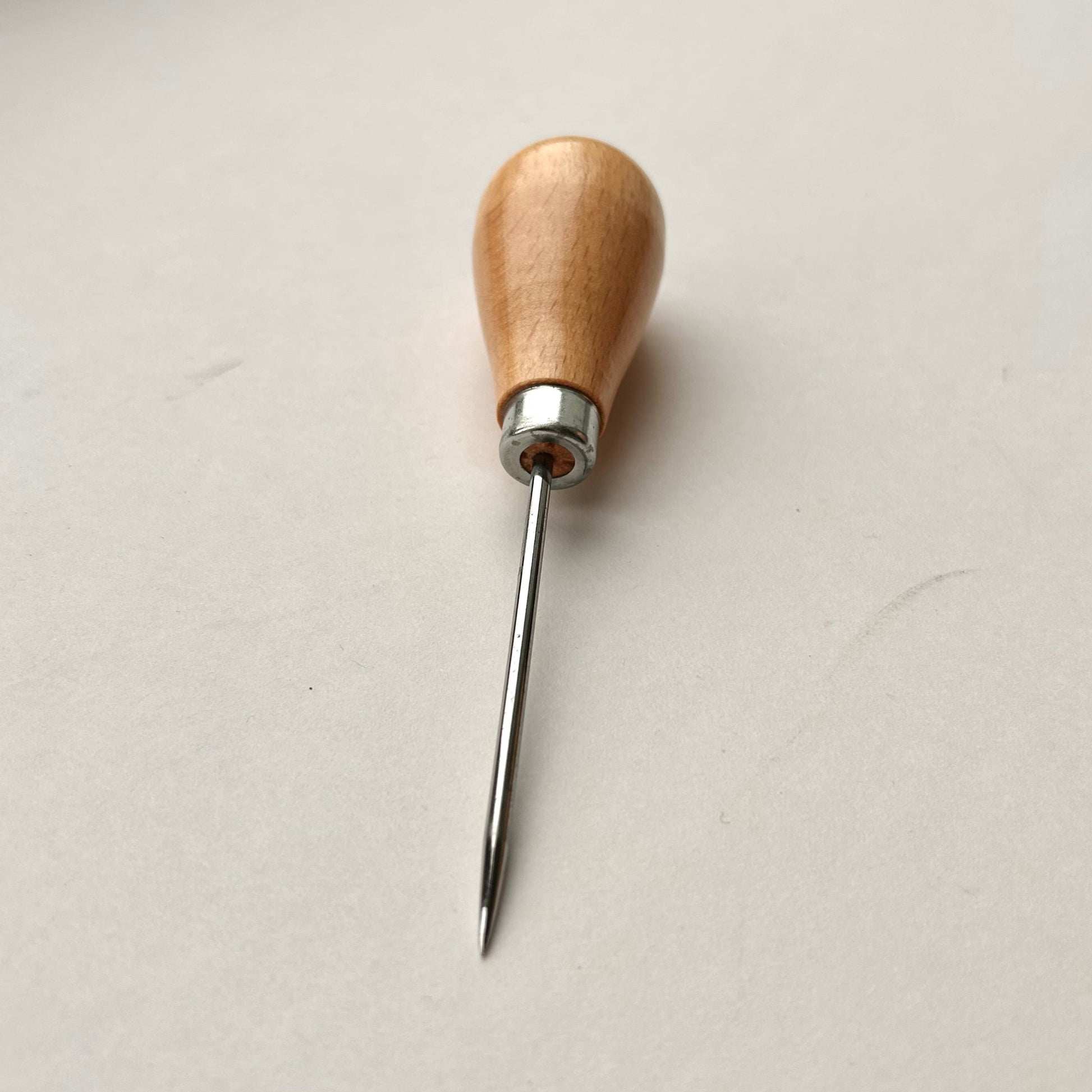 Wooden-handled awl on a white background